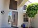 Close up of front door showcasing the covered entryway with a decorative tree and exterior lighting at 1681 S Karen Dr, Chandler, AZ 85286