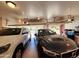 Garage with two cars parked, garage door openers, and storage at 1681 S Karen Dr, Chandler, AZ 85286
