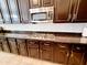 Modern kitchen features stainless steel appliances, granite countertops, and dark wood cabinets at 1681 S Karen Dr, Chandler, AZ 85286
