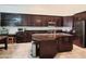 Spacious kitchen boasts dark wood cabinetry, stainless steel appliances, and a large center island at 1681 S Karen Dr, Chandler, AZ 85286
