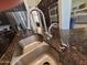 Modern kitchen sink with stainless steel fixtures and a granite countertop at 1681 S Karen Dr, Chandler, AZ 85286