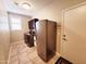 Well-equipped laundry room with washer, dryer, refrigerator, storage and tile floors at 1681 S Karen Dr, Chandler, AZ 85286