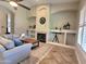 Bright living room with a fireplace, custom built-ins and large windows with plantation shutters at 1681 S Karen Dr, Chandler, AZ 85286