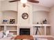 Bright living room with a fireplace, custom built-ins and large windows with plantation shutters at 1681 S Karen Dr, Chandler, AZ 85286