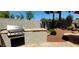 Outdoor kitchen with a built-in grill and countertop space for entertaining at 1681 S Karen Dr, Chandler, AZ 85286