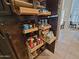 Walk-in pantry equipped with pull-out shelves to maximize storage space and organization at 1681 S Karen Dr, Chandler, AZ 85286