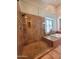 Luxurious bathroom featuring a glass-enclosed shower, soaking tub, and tiled walls, offering a spa-like experience at 1681 S Karen Dr, Chandler, AZ 85286