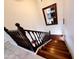 Elegant wooden staircase with dark railing, leading to the upper level of the home at 1681 S Karen Dr, Chandler, AZ 85286