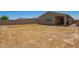 Spacious backyard featuring a covered patio, perfect for outdoor entertaining and relaxation at 17344 W Red Fox Rd, Surprise, AZ 85387