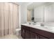Bathroom features a double sink vanity and framed mirror with a large window at 17344 W Red Fox Rd, Surprise, AZ 85387