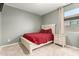 Bedroom with an ornate white bedframe, plush carpet, and neutral walls at 17344 W Red Fox Rd, Surprise, AZ 85387