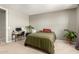 Comfortable bedroom with carpet, desk and chair set, providing a relaxed and functional living space at 17344 W Red Fox Rd, Surprise, AZ 85387