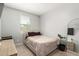Minimalist bedroom with neutral colored walls and decor, featuring a large window at 17344 W Red Fox Rd, Surprise, AZ 85387