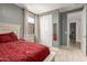 Bedroom featuring sliding-door closet, neutral walls, and carpeted flooring at 17344 W Red Fox Rd, Surprise, AZ 85387