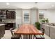 Eat-in kitchen featuring a long wooden table and stainless steel appliances in a modern design at 17344 W Red Fox Rd, Surprise, AZ 85387