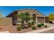 Charming single-story home with a two-car garage and desert landscaping under a clear blue sky at 17344 W Red Fox Rd, Surprise, AZ 85387