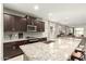 Modern kitchen boasting granite counters, stainless steel appliances, and an open layout for entertaining at 17344 W Red Fox Rd, Surprise, AZ 85387