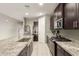 Well-equipped kitchen with a stainless steel refrigerator, granite countertops, and ample storage at 17344 W Red Fox Rd, Surprise, AZ 85387