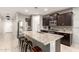 Spacious kitchen with granite countertops, stainless steel appliances, a large island, and seating at 17344 W Red Fox Rd, Surprise, AZ 85387