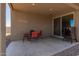 Covered patio features a dining table, chairs, and a grill perfect for outdoor entertaining at 17344 W Red Fox Rd, Surprise, AZ 85387