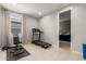 Workout room featuring a window, a treadmill, bench press and rubber flooring at 17344 W Red Fox Rd, Surprise, AZ 85387