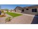 Backyard with artificial turf, desert landscaping and stone walkway at 19042 E Arrowhead Trl, Queen Creek, AZ 85142