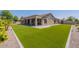 Backyard with artificial turf, shaded patio and desert landscaping at 19042 E Arrowhead Trl, Queen Creek, AZ 85142