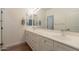 Bathroom features double sink vanity with white cabinets, ample counter space, and modern fixtures at 19042 E Arrowhead Trl, Queen Creek, AZ 85142
