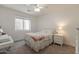 Cozy bedroom with a bright window, plush bedding, and a bedside table offering a comfortable retreat at 19042 E Arrowhead Trl, Queen Creek, AZ 85142