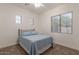 Cozy bedroom with a double bed, carpet floors, and a large window with blinds at 19042 E Arrowhead Trl, Queen Creek, AZ 85142