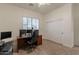 Bedroom featuring a large desk, comfortable chair, and a window with blinds at 19042 E Arrowhead Trl, Queen Creek, AZ 85142