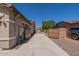 The home's exterior features a concrete driveway with dual gates and a well-maintained landscape at 19042 E Arrowhead Trl, Queen Creek, AZ 85142