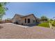 The exterior of this home features desert landscaping and a low maintenance backyard with turf at 19042 E Arrowhead Trl, Queen Creek, AZ 85142