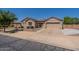 Charming single-story home showcasing a spacious driveway and desert landscaping at 19042 E Arrowhead Trl, Queen Creek, AZ 85142