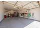 Spacious garage with epoxy floors, ample storage and well-organized tool rack at 19042 E Arrowhead Trl, Queen Creek, AZ 85142