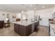 Modern kitchen featuring a large island with marble countertops and stainless steel appliances at 19042 E Arrowhead Trl, Queen Creek, AZ 85142