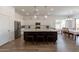 Bright kitchen featuring a marble island and eat-in dining area at 19042 E Arrowhead Trl, Queen Creek, AZ 85142