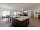 Spacious kitchen with a large island, marble countertops, and an adjacent dining area and living area at 19042 E Arrowhead Trl, Queen Creek, AZ 85142