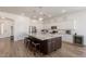 Well-lit kitchen with a central island, white cabinets, and modern appliances at 19042 E Arrowhead Trl, Queen Creek, AZ 85142