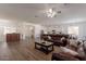 Open-concept living room with modern furniture and hardwood floors at 19042 E Arrowhead Trl, Queen Creek, AZ 85142