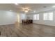 Open-concept living room and dining area features modern flooring and lots of natural light at 19042 E Arrowhead Trl, Queen Creek, AZ 85142