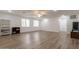 Expansive living room with light wood flooring, featuring a ceiling fan and natural light at 19042 E Arrowhead Trl, Queen Creek, AZ 85142