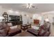 Inviting living room featuring a large TV and entertainment center at 19042 E Arrowhead Trl, Queen Creek, AZ 85142