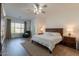 Main bedroom featuring a ceiling fan, bedside lamps, and an inviting sitting area at 19042 E Arrowhead Trl, Queen Creek, AZ 85142