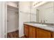 Bathroom with a wood vanity, granite countertop, decorative mirror, and a walk-in tiled shower at 1976 N Lemon Tree Ln # 16, Chandler, AZ 85224