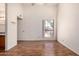 Bright bedroom featuring hardwood floors, a large window, and an ensuite bathroom at 1976 N Lemon Tree Ln # 16, Chandler, AZ 85224