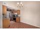 Eat-in dining area next to kitchen featuring chandelier and neutral colors at 1976 N Lemon Tree Ln # 16, Chandler, AZ 85224