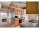 Traditional kitchen featuring stainless steel appliances, granite countertops, and warm wood cabinetry at 1976 N Lemon Tree Ln # 16, Chandler, AZ 85224