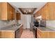 Traditional kitchen featuring granite countertops, stainless steel appliances, and warm wood cabinets at 1976 N Lemon Tree Ln # 16, Chandler, AZ 85224