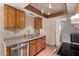Galley kitchen featuring warm wood cabinets, stainless steel appliances, and granite countertops at 1976 N Lemon Tree Ln # 16, Chandler, AZ 85224